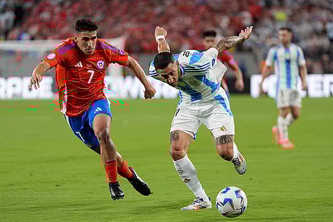 Angel Di Maria and Marcelino Nunez vie for the ball
